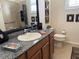 Well-lit bathroom with granite countertop, stylish decor, and neutral paint at 14714 5Th Ne Ter, Bradenton, FL 34212