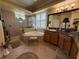 Bright bathroom with large soaking tub, granite vanity, and tiled shower at 14714 5Th Ne Ter, Bradenton, FL 34212