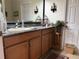 Neutral bathroom with wood cabinets, granite countertop, and a decorative rug at 14714 5Th Ne Ter, Bradenton, FL 34212