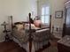 Cozy bedroom featuring wood floors, shuttered window, and decorative artwork at 14714 5Th Ne Ter, Bradenton, FL 34212