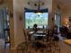 Charming breakfast nook with a glass table and a bay window overlooking the backyard at 14714 5Th Ne Ter, Bradenton, FL 34212