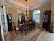 Elegant dining room with a tray ceiling, chandelier, large window, and classic furnishings at 14714 5Th Ne Ter, Bradenton, FL 34212
