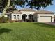 Charming single-story home with a lush green lawn and beautifully landscaped front yard with a two car garage at 14714 5Th Ne Ter, Bradenton, FL 34212