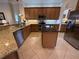 Modern kitchen with stainless steel appliances, granite countertops, and a center island at 14714 5Th Ne Ter, Bradenton, FL 34212