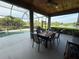 Screened-in lanai with a dining table, ceiling fan, and views of the pool and a pond at 14714 5Th Ne Ter, Bradenton, FL 34212