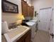 Functional laundry room with utility sink, washer and dryer, and storage cabinets at 14714 5Th Ne Ter, Bradenton, FL 34212