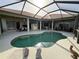 Wide shot of pool area and multiple seating areas within screened-in lanai at 14714 5Th Ne Ter, Bradenton, FL 34212