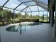 View of the kidney-shaped pool and screened-in lanai with a lake in the background at 14714 5Th Ne Ter, Bradenton, FL 34212