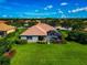 Aerial view of house with verdant green lawn and screened pool at 14714 5Th Ne Ter, Bradenton, FL 34212