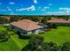 Aerial view of the home's backyard, showcasing lush landscaping and a screened patio at 14714 5Th Ne Ter, Bradenton, FL 34212