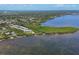 Aerial view of waterfront property and the surrounding lush landscape and blue waters at 1500 Sunset Rd # B4, Tarpon Springs, FL 34689