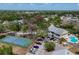 Aerial shot of community with mature trees, tennis courts, pool, and designated parking at 1500 Sunset Rd # B4, Tarpon Springs, FL 34689