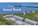 Aerial view of complex with beach access to tranquil waters at 1500 Sunset Rd # B4, Tarpon Springs, FL 34689