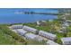 Panoramic aerial view of multi-Gathering homes with scenic waterfront and lush greenery at 1500 Sunset Rd # B4, Tarpon Springs, FL 34689