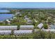 Stunning aerial view of a community featuring multiple residences, a lake, and lush surroundings at 1500 Sunset Rd # B4, Tarpon Springs, FL 34689