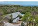 Beautiful home with a gray roof and a pool surrounded by lush greenery at 1500 Sunset Rd # B4, Tarpon Springs, FL 34689