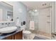 Modern bathroom features a large shower with stone floor and a unique vanity at 1500 Sunset Rd # B4, Tarpon Springs, FL 34689