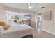 Cozy bedroom with beach view TV, modern light fixture, and full mirrored closet at 1500 Sunset Rd # B4, Tarpon Springs, FL 34689