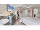 Bright bedroom has ceiling fan, table with chairs, and mirrored closet at 1500 Sunset Rd # B4, Tarpon Springs, FL 34689