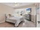 Comfortable bedroom with a ceiling fan, accent furniture, and natural light at 1500 Sunset Rd # B4, Tarpon Springs, FL 34689