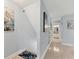 Bright hallway features hardwood floors, modern decor, and access to bathroom at 1500 Sunset Rd # B4, Tarpon Springs, FL 34689