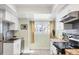 Charming kitchen features bright white cabinets, wood countertops, skylight, and stainless steel appliances at 1500 Sunset Rd # B4, Tarpon Springs, FL 34689