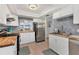 Modern kitchen with stainless steel appliances, butcher block countertops, and tile backsplash at 1500 Sunset Rd # B4, Tarpon Springs, FL 34689