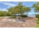 Secluded outdoor setting with shady trees and a glimpse of the water at 1500 Sunset Rd # B4, Tarpon Springs, FL 34689