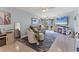 Open living room features ceiling fan and sliding glass doors leading to outside at 1500 Sunset Rd # B4, Tarpon Springs, FL 34689