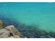 Captivating ocean view, showcasing clear turquoise waters with exposed rocks that add to a truly mesmerizing waterfront experience at 1500 Sunset Rd # B4, Tarpon Springs, FL 34689
