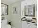 Stylish powder room features a decorative mirror, vessel sink, and elegant finishes at 1500 Sunset Rd # B4, Tarpon Springs, FL 34689