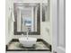 The powder room has a unique sink and mirror, complemented by modern lighting at 1500 Sunset Rd # B4, Tarpon Springs, FL 34689