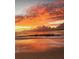 Sunset over ocean with orange clouds and rippling water, creating a serene and picturesque waterfront view with soft reflections at 1500 Sunset Rd # B4, Tarpon Springs, FL 34689