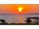 A peaceful view of the sunset over the water, with a charming dock that offers a serene and private waterfront experience at 1500 Sunset Rd # B4, Tarpon Springs, FL 34689