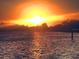 Beautiful water view with bright orange sunset reflecting on the peaceful water and silhouetted shoreline at 1500 Sunset Rd # B4, Tarpon Springs, FL 34689
