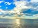 Stunning water view featuring a blue sky filled with fluffy, picturesque clouds reflecting on the serene sea at 1500 Sunset Rd # B4, Tarpon Springs, FL 34689