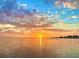 Beautiful waterfront view of the ocean with a colorful sunset reflecting on the water at 1500 Sunset Rd # B4, Tarpon Springs, FL 34689