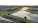 Scenic aerial view of backyard space, a picturesque lake, and the community's harmonious layout at 15344 Serene Shores Loop, Bradenton, FL 34211