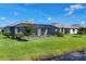 Lush backyard with screened-in pool and waterfront access, perfect for outdoor living and recreation at 15344 Serene Shores Loop, Bradenton, FL 34211