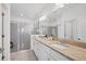 Modern bathroom with double vanity, granite countertops, and large glass-enclosed shower at 15344 Serene Shores Loop, Bradenton, FL 34211