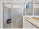 Contemporary bathroom with a glass-enclosed shower featuring gray tiling and granite countertop at 15344 Serene Shores Loop, Bradenton, FL 34211