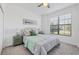 Bright bedroom with cozy decor, featuring a comfortable bed and a large window offering plenty of light at 15344 Serene Shores Loop, Bradenton, FL 34211