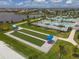 Aerial view of bocce ball courts with swimming pool and community in the background at 15344 Serene Shores Loop, Bradenton, FL 34211