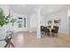 The open-concept dining space has a glass table and tile floors at 15344 Serene Shores Loop, Bradenton, FL 34211