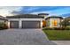Beautiful home featuring a three-car garage, well-maintained landscaping, and an inviting entrance at 15344 Serene Shores Loop, Bradenton, FL 34211