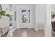 Bright foyer with glass front door, neutral tile flooring, and views into other rooms at 15344 Serene Shores Loop, Bradenton, FL 34211