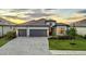 Stunning single-Gathering home boasts a paver driveway, manicured lawn, and a three-car garage at 15344 Serene Shores Loop, Bradenton, FL 34211
