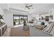 Open-concept living room with lanai access and a view into the modern kitchen at 15344 Serene Shores Loop, Bradenton, FL 34211