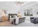 Relaxing main bedroom with tray ceiling, plush bed, sitting area, and a bright window at 15344 Serene Shores Loop, Bradenton, FL 34211