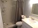Bathroom showcasing a tiled shower with glass door, toilet, vanity with sink, and modern fixtures at 1801 Gulf N Dr # 207, Bradenton Beach, FL 34217